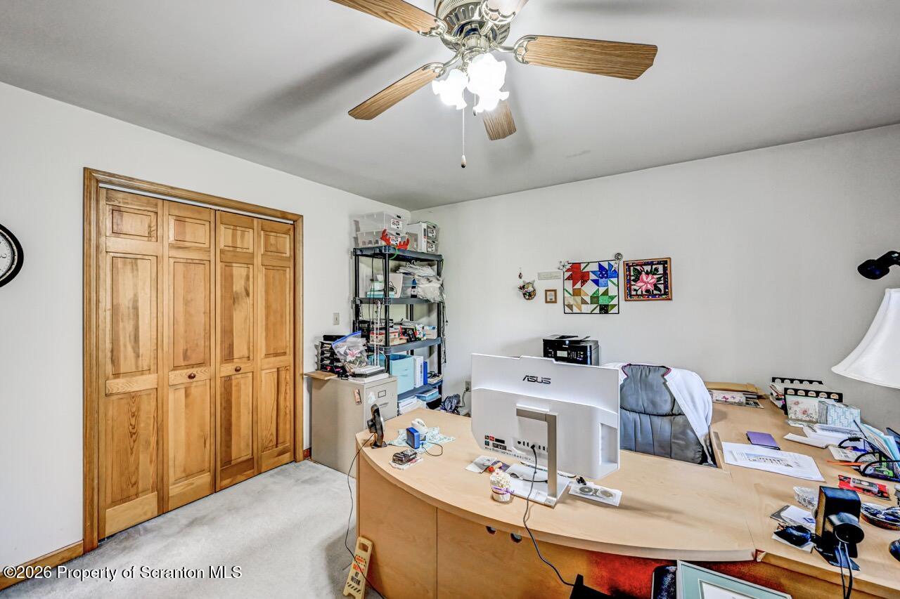 314 Reynolds Road Factoryville, PA 18419 - Photo 40 of 58 a workspace with furniture cabinet and a chandelier fan