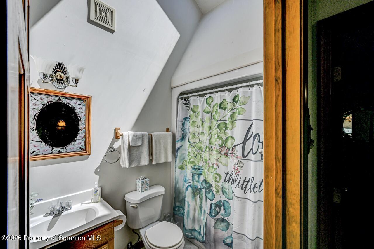 314 Reynolds Road Factoryville, PA 18419 - Photo 42 of 58 a bathroom with a toilet a sink and a shower curtain
