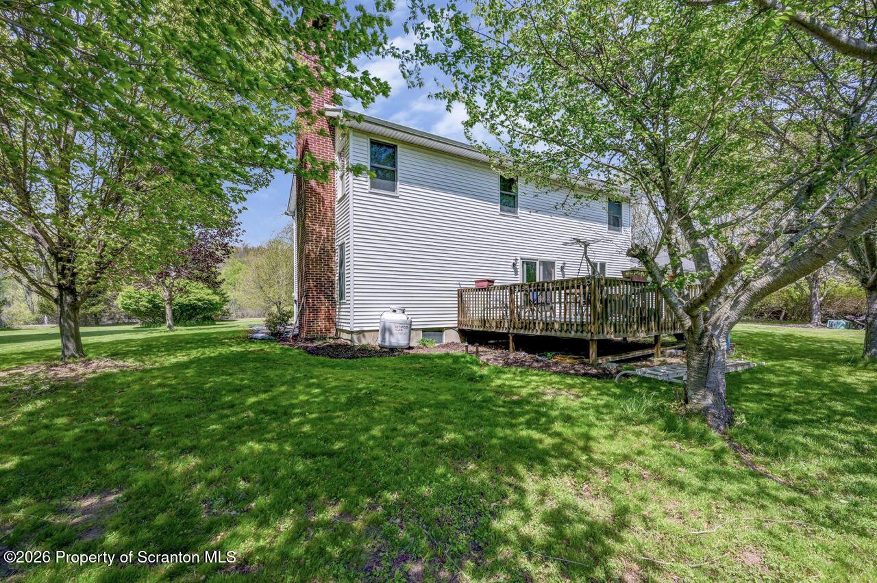 314 Reynolds Road Factoryville, PA 18419 - Photo 52 of 58 a view of backyard with house and trees in the background