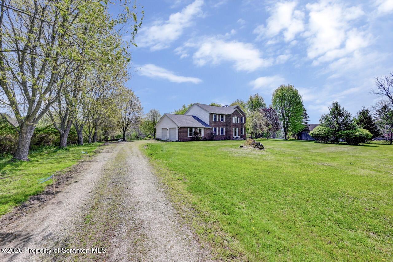 314 Reynolds Road Factoryville, PA 18419 - Photo 57 of 58 a view of a garden with a building in the background