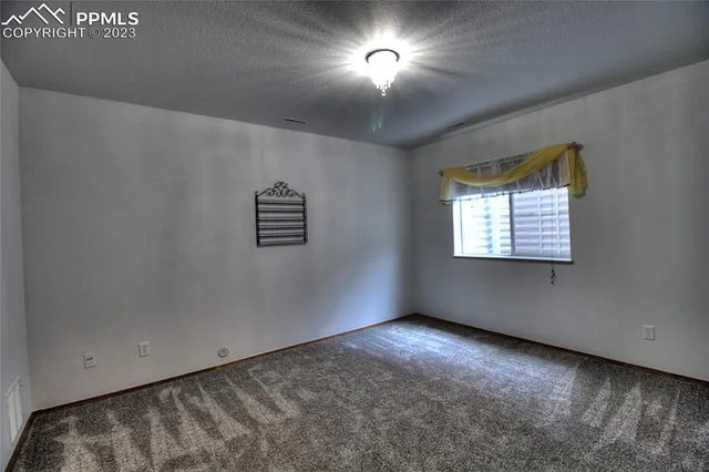 a view of a chair and table in the garden