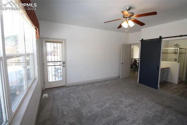 an empty room with windows and closet