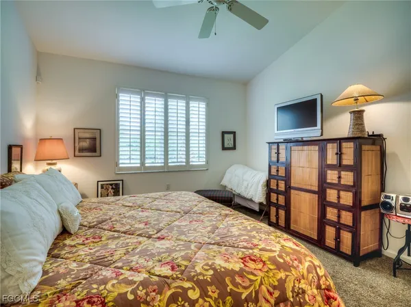 a bedroom with a bed a dresser and book shelf