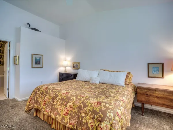 a bedroom with a bed and a lamp with window