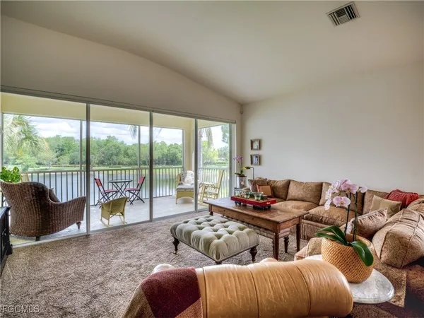 a living room with furniture and a floor to ceiling window