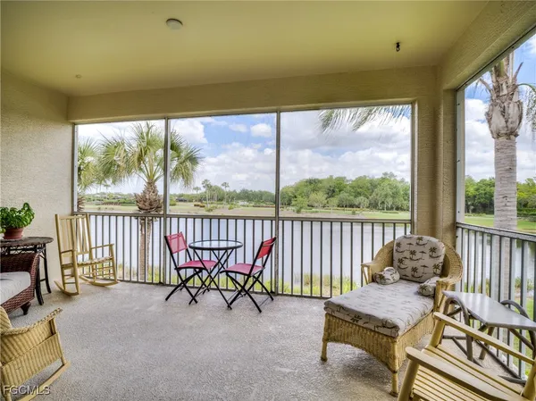 a balcony with furniture and a potted plant