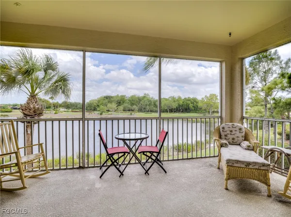 a balcony with couple of chairs and a couch