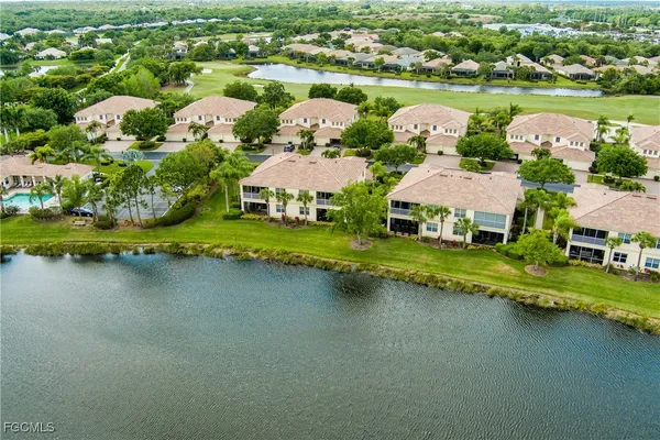 an aerial view of a house with a garden and lake view