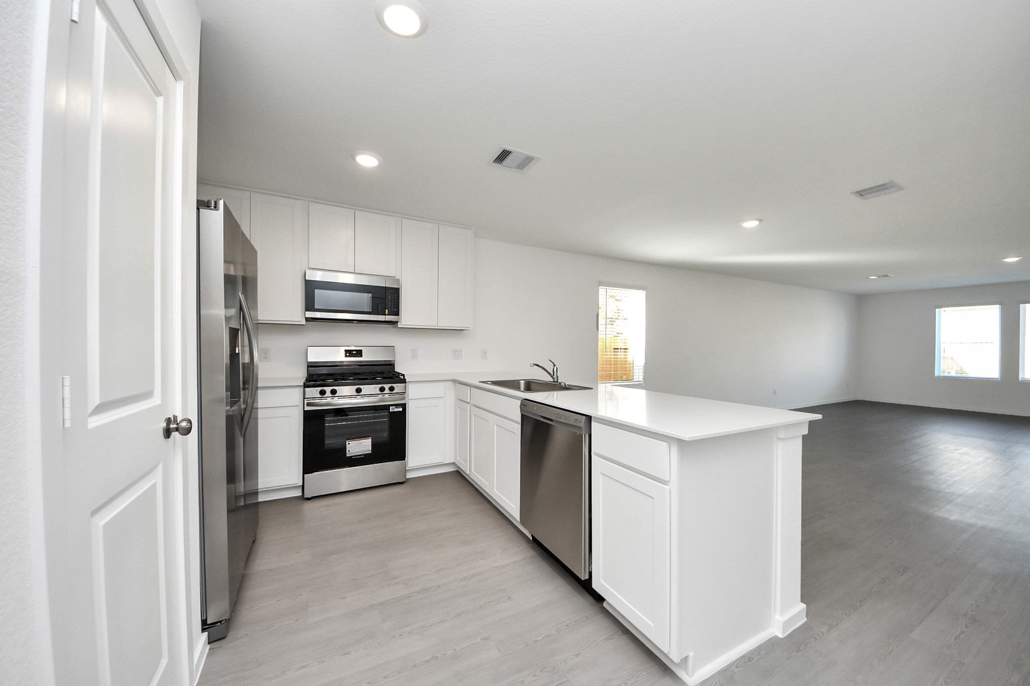 2523 Night Emerald Drive Rosharon, TX 77583 - Photo 12 of 42 a kitchen with a refrigerator a stove top oven and cabinets