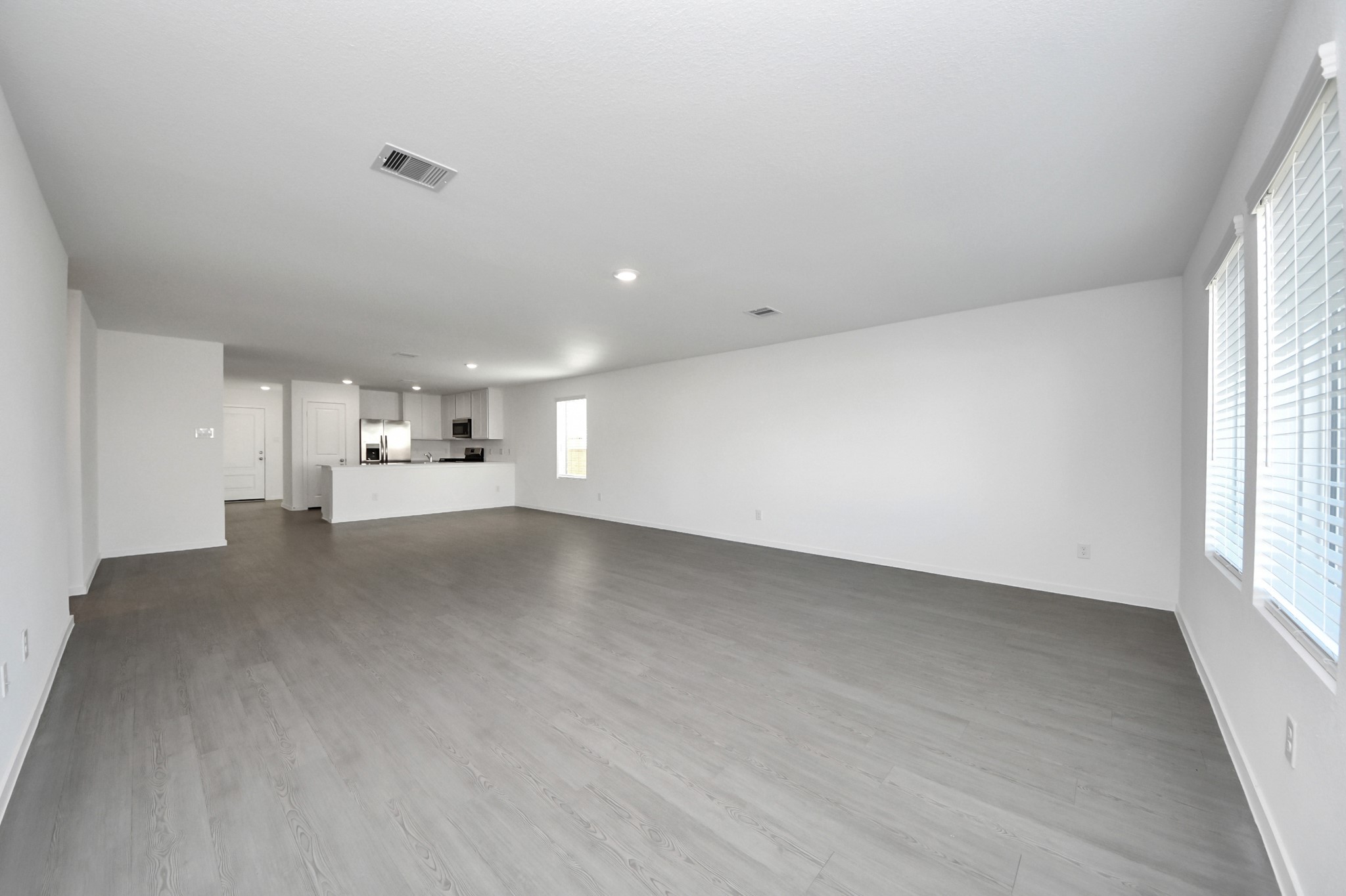 2523 Night Emerald Drive Rosharon, TX 77583 - Photo 10 of 42 a view of a kitchen with white cabinets and wooden floor