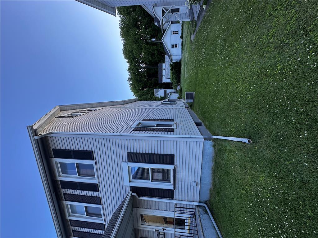 5128 3rd Street Whitehall, PA 18052 - Photo 10 of 26 A classic facade with shuttered windows, nestled beside a generous green lawn.