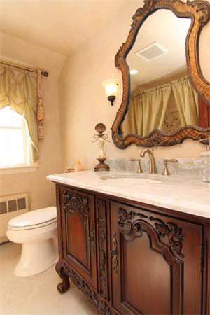 64 Myopia Road Winchester, MA 01890 - Photo 17 of 30 a bathroom with a sink a toilet and a mirror