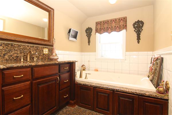 64 Myopia Road Winchester, MA 01890 - Photo 23 of 30 a bathroom with a granite countertop sink mirror and a bathtub