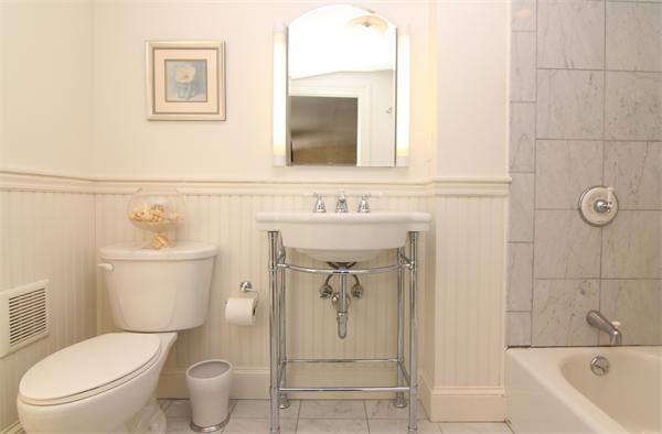 64 Myopia Road Winchester, MA 01890 - Photo 28 of 30 a white toilet sitting next to a bathroom sink