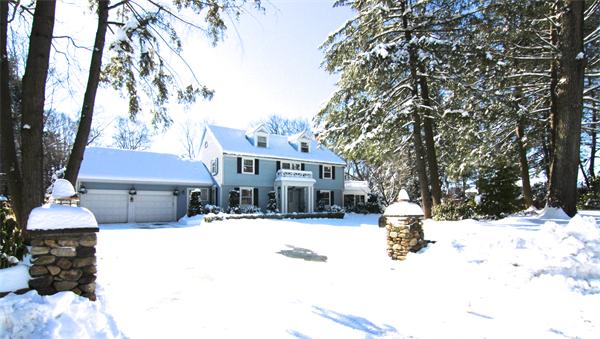 64 Myopia Road Winchester, MA 01890 - Photo 30 of 30 a front view of a house with a yard covered in snow