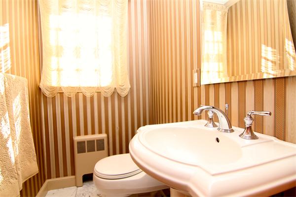 64 Myopia Road Winchester, MA 01890 - Photo 10 of 30 a bathroom with a sink a toilet and mirror