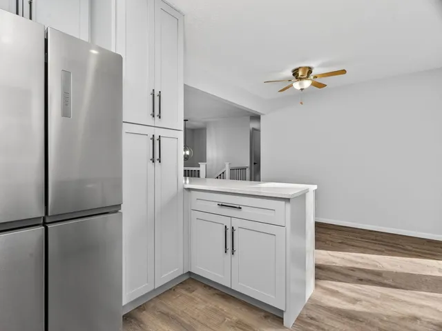 a kitchen with a refrigerator and a sink