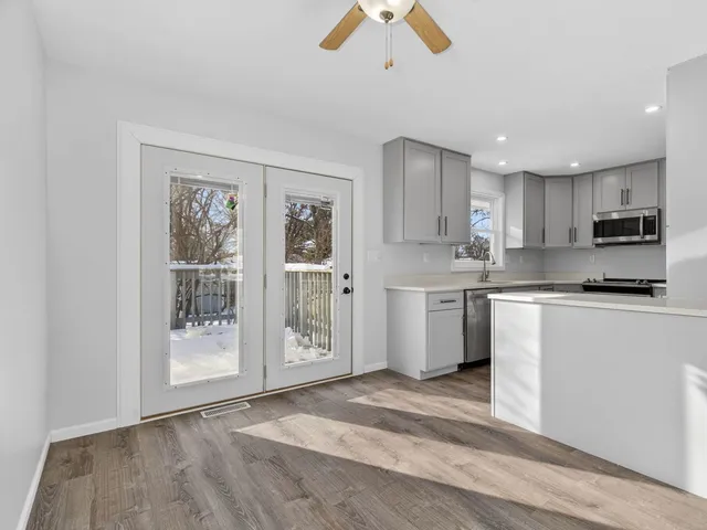 a kitchen with stainless steel appliances granite countertop a stove a sink and a refrigerator