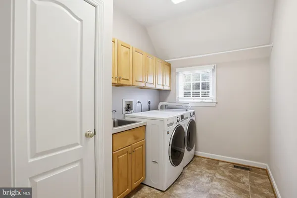 a utility room with sink dryer and washer