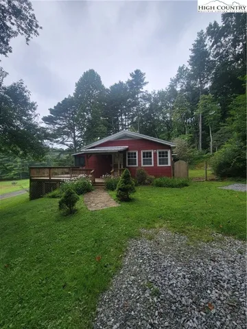 a view of house with backyard