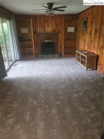 an empty room with furniture and a fireplace