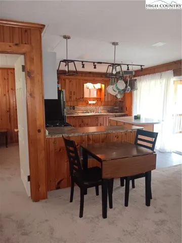 a dining room with a sink and chairs