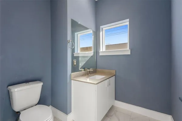 a bathroom with a tub sink shower and two mirror