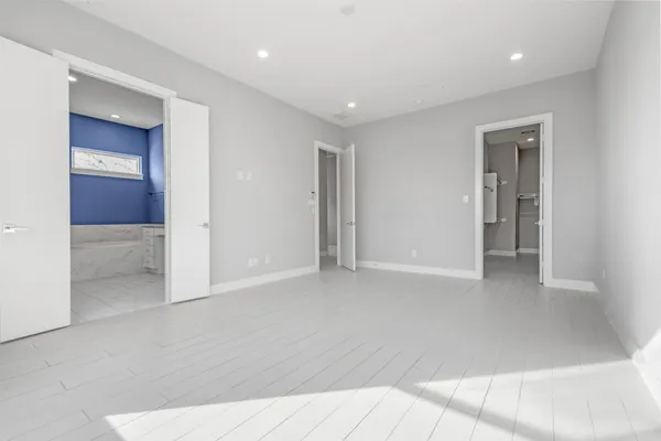 a view of a hallway with wooden floor and entryway