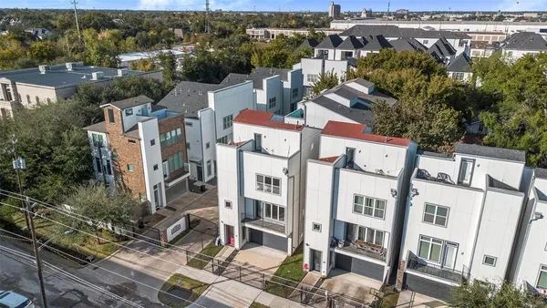 an aerial view of residential houses with outdoor space