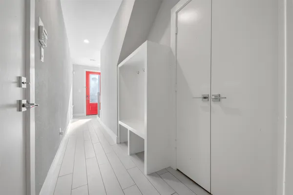 a view of an empty room with wooden floor