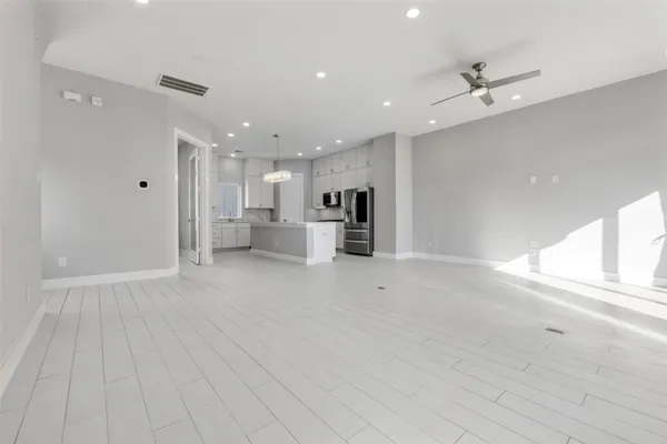 a view of kitchen with a sink stainless steel appliances and cabinets