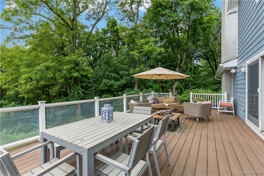 52 Old Manitou Road Garrison, NY 10524 - Photo 25 of 33 Large deck off family room features a built in fire pit and room for several guests to spread out safely.