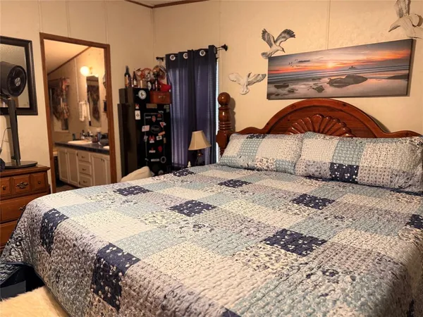 a bedroom with a bed and a mirror