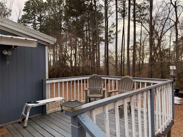 a view of backyard with deck and trees