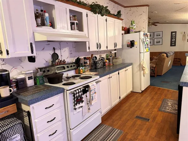 a kitchen with stainless steel appliances a stove a sink and cabinets