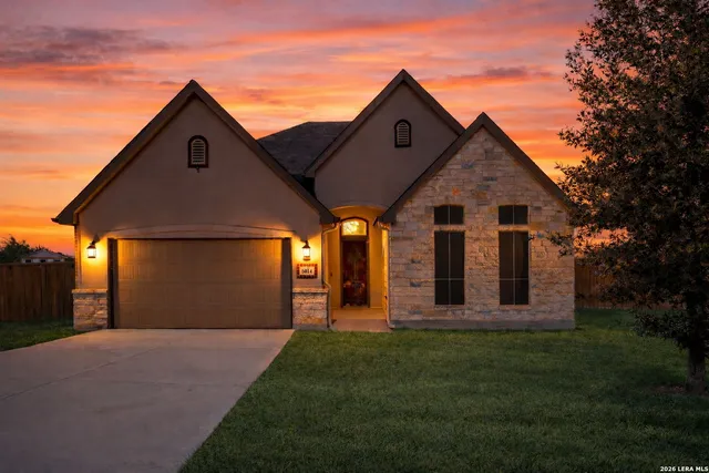 a front view of a house with a yard and garage