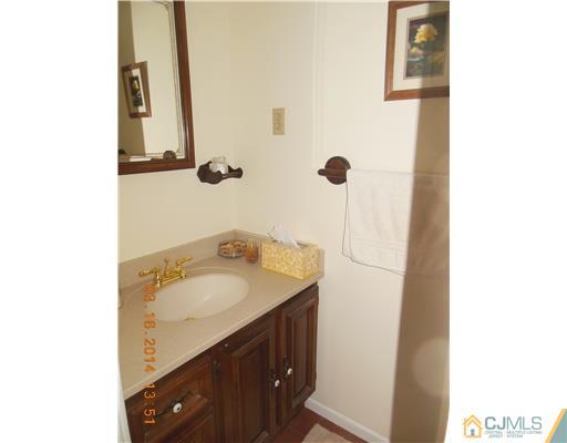 29 Hughes Road Somerset, NJ 08873 - Photo 11 of 19 a bathroom with a sink and mirror