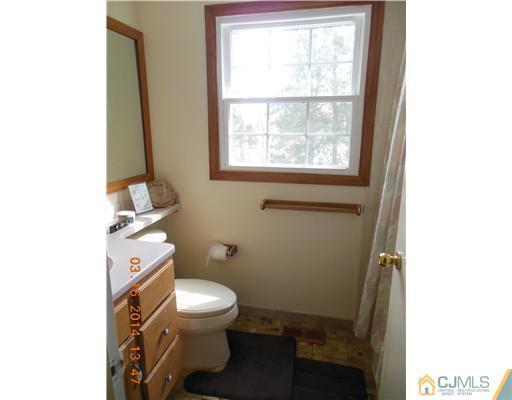29 Hughes Road Somerset, NJ 08873 - Photo 12 of 19 a white toilet sitting next to a window