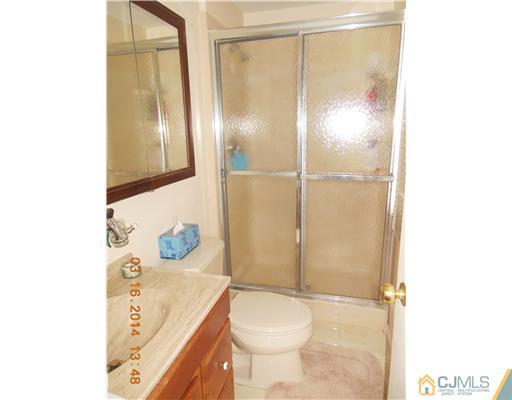29 Hughes Road Somerset, NJ 08873 - Photo 13 of 19 a bathroom with a sink a toilet and shower