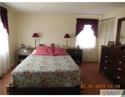 29 Hughes Road Somerset, NJ 08873 - Photo 17 of 19 a bed sitting in a bedroom next to a window with dresser
