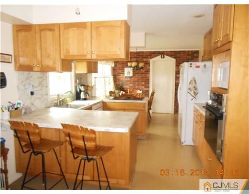 29 Hughes Road Somerset, NJ 08873 - Photo 8 of 19 a view of a kitchen with kitchen island a large window and a sink