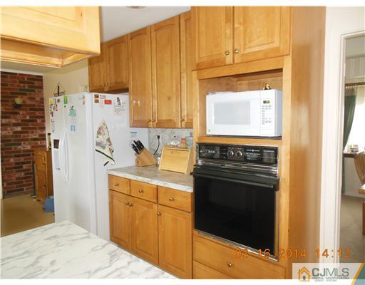 29 Hughes Road Somerset, NJ 08873 - Photo 9 of 19 a kitchen with a refrigerator stove and cabinets
