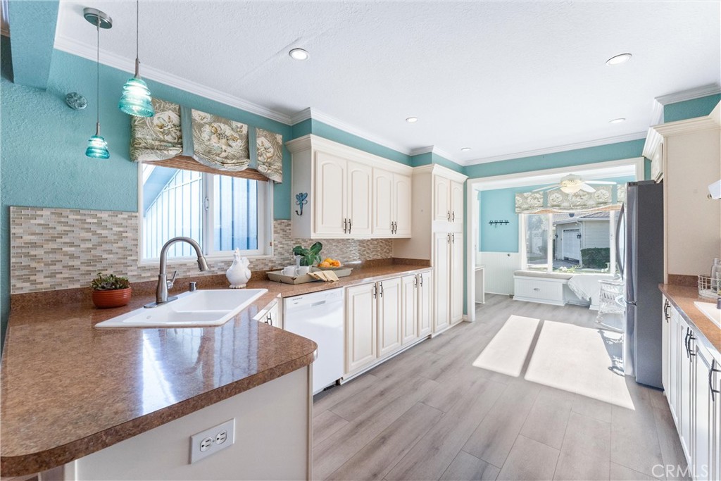 2529 Shadow Santa Ana, CA 92705 - Photo 14 of 45 a large kitchen with kitchen island a large counter space a sink stainless steel appliances and cabinets