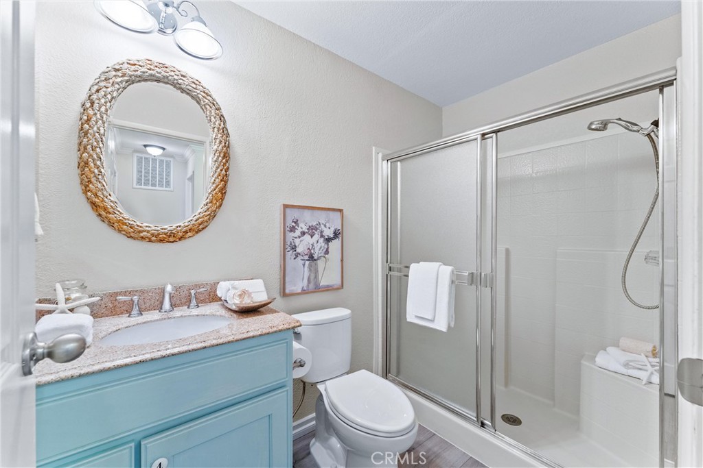2529 Shadow Santa Ana, CA 92705 - Photo 22 of 45 a bathroom with a granite countertop toilet sink vanity and shower
