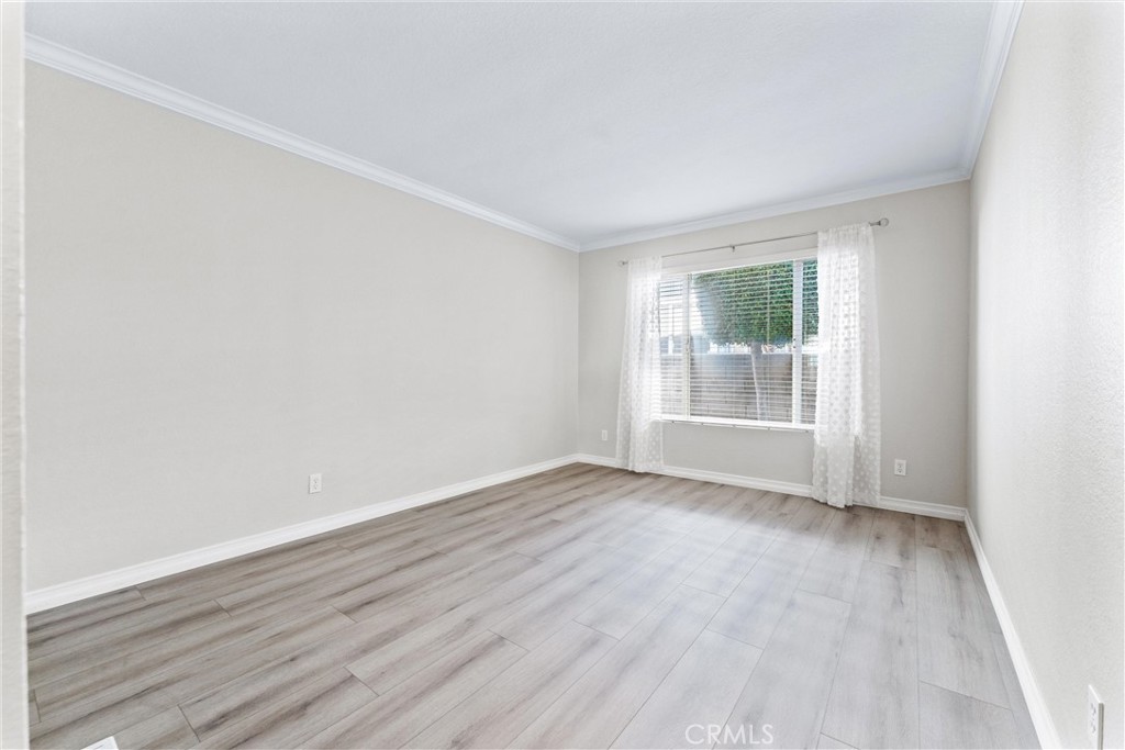2529 Shadow Santa Ana, CA 92705 - Photo 29 of 45 an empty room with wooden floor and windows