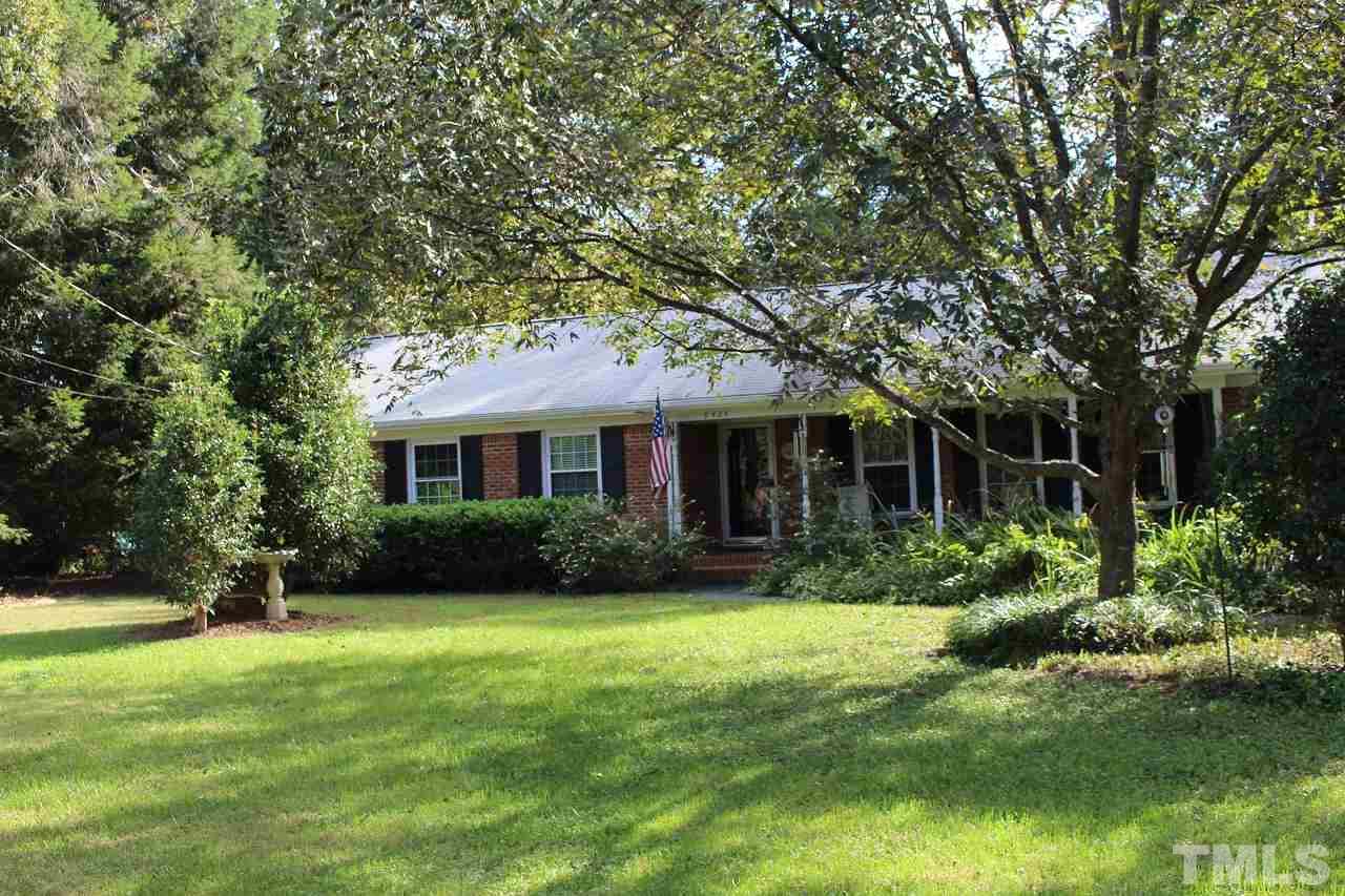 6424 Litchford Road Raleigh, NC 27615 - Photo 2 of 8 a front view of a house with a yard and trees
