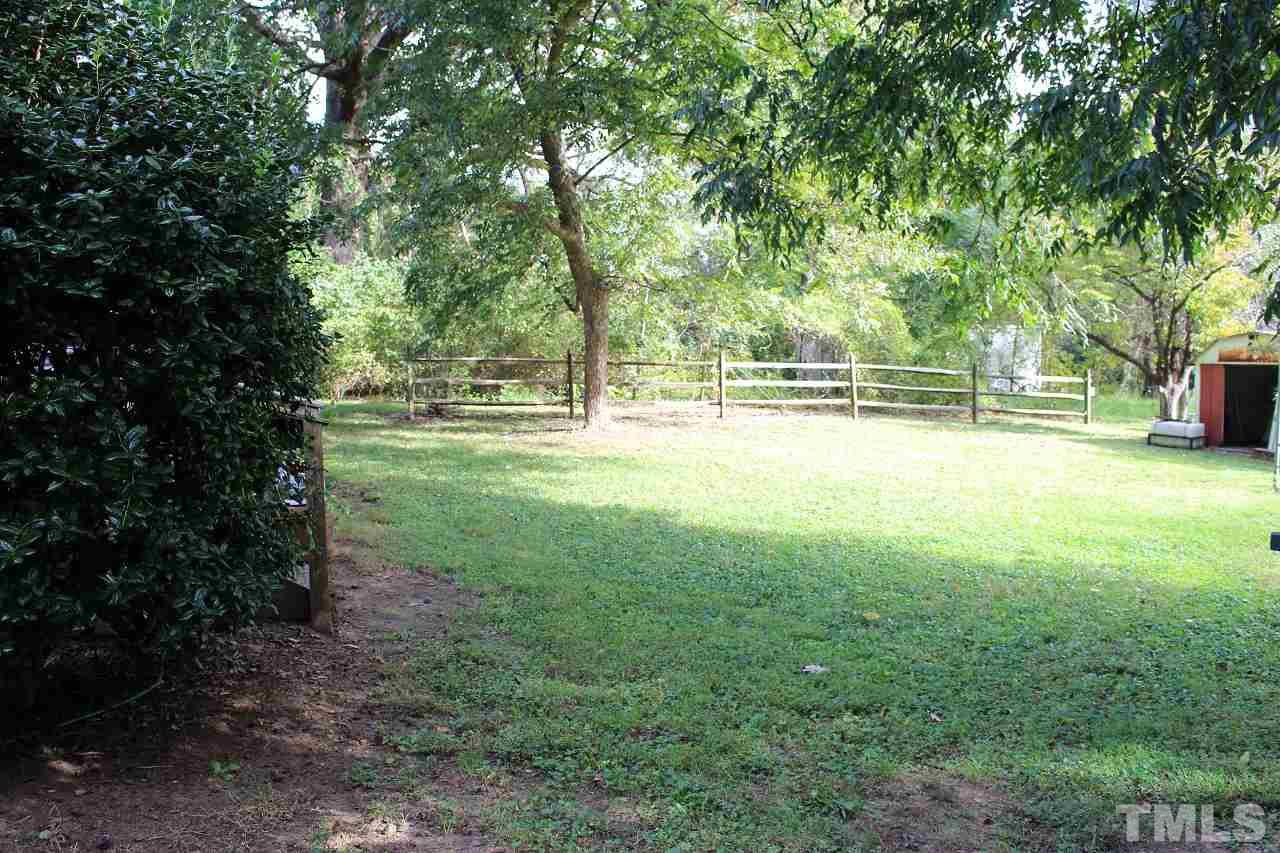 6424 Litchford Road Raleigh, NC 27615 - Photo 7 of 8 a view of yard with green space and trees in the background