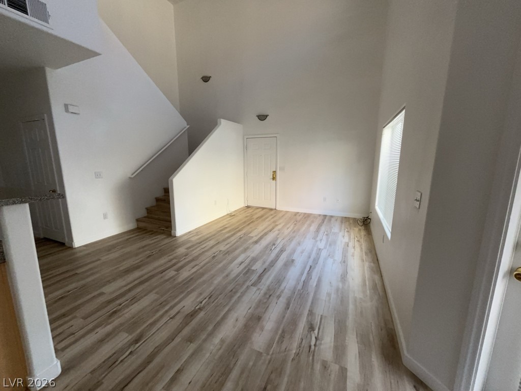 4915 East Russell Road, Unit 143 Las Vegas, NV 89120 - Photo 1 of 10 A spacious, airy living area features high ceilings and lustrous hardwood-style flooring, ready for personalized touches.