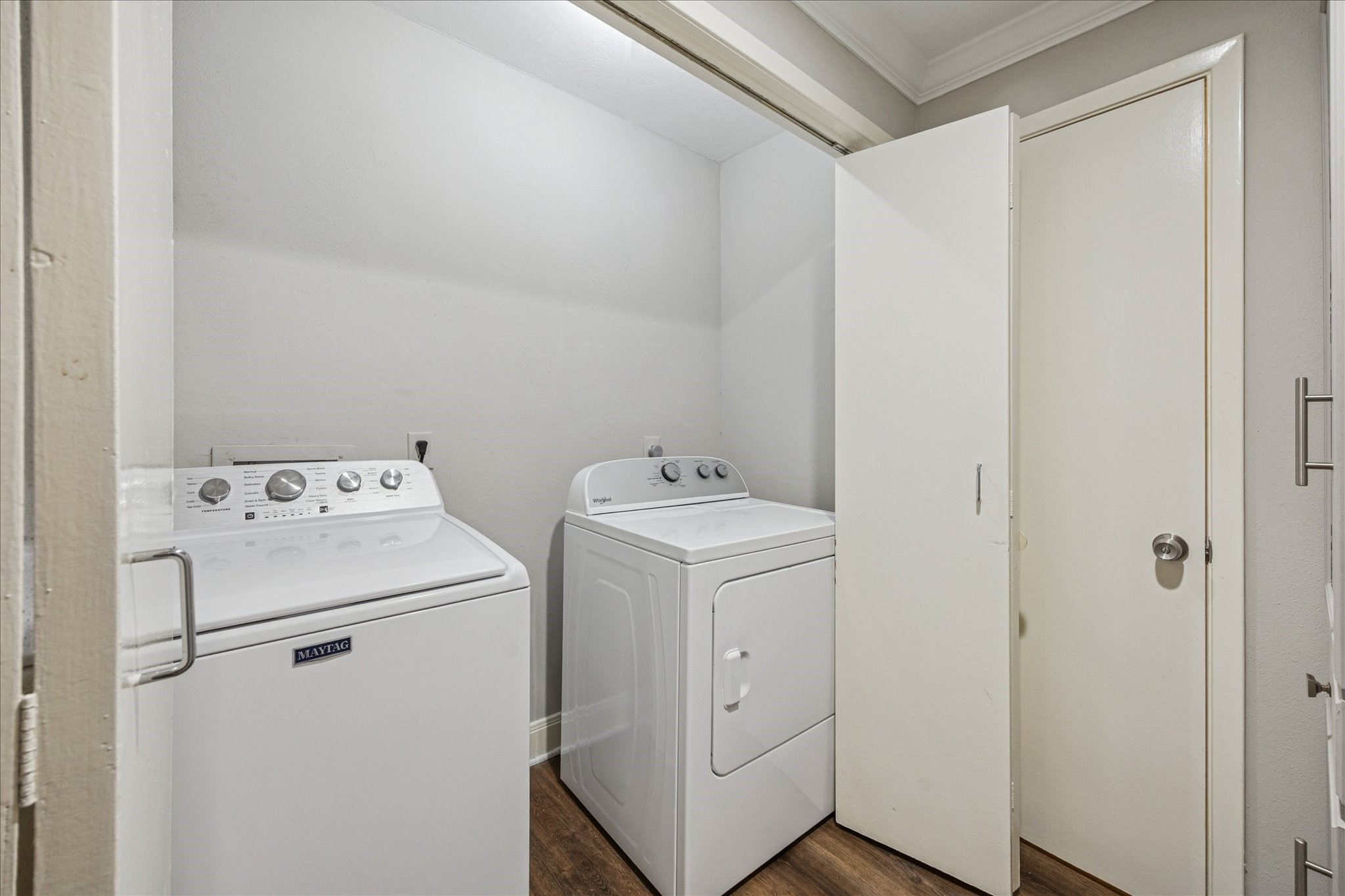 1615 Prairie Mark Lane Houston, TX 77077 - Photo 13 of 25 Just past the kitchen is the hallway to the utility room - washer & dryer stay! And they were purchased in 2024/2025. The closed door is the half bath.