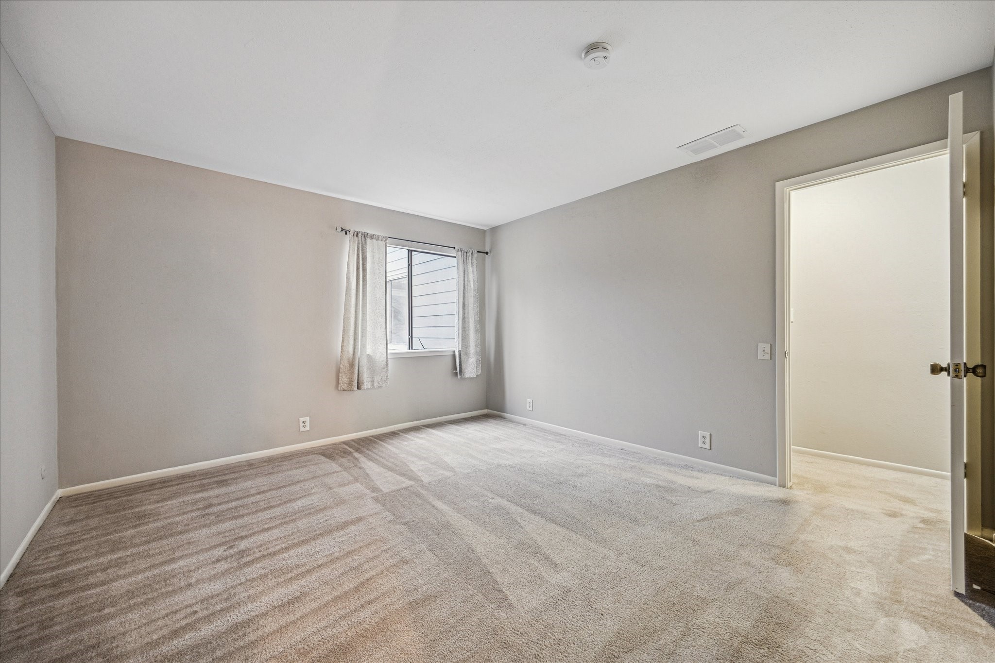 1615 Prairie Mark Lane Houston, TX 77077 - Photo 15 of 25 Once at the top of the stairs, you turn right to the hallway and the secondary bedroom is the first one on the right. The window looks out to the courtyard. Carpet were just professionally cleaned. The closet is to the right of the open door.